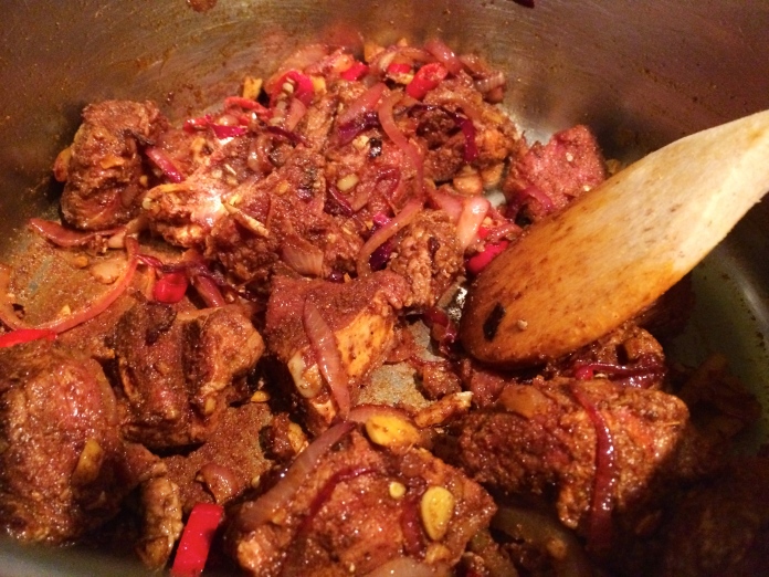 As soon as the curry, chili and tumeric powder has mixed into the onion mixture, add in the marinated beef and brown. Make sure you are stirring consistently to ensure that the pan does not burn. 